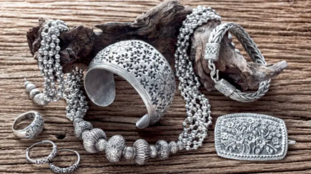Collection of antique traditional silver jewelry on old wood