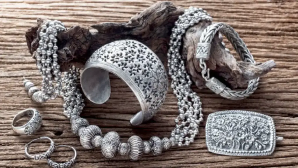 Collection of antique traditional silver jewelry on old wood