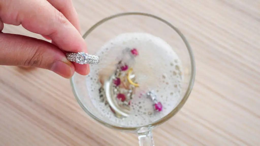Jeweller hand cleaning vintage jewelry diamond ring