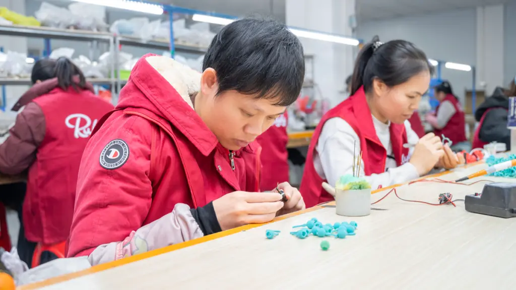 Wax finishing step in private label jewelry production at a 925 sterling silver factory