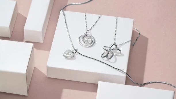 A display of an elegant silver jewelry set featuring a necklace